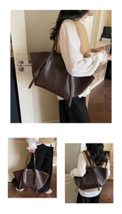 Detailed view of the dark brown vintage leather texture and slim shoulder straps on the tote