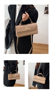 Detail of lychee pattern leather handbag with gold metal clasp and top handle