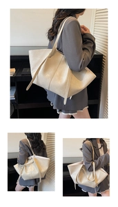 Detail view of large cream tote bag showing soft faux leather texture and side profile