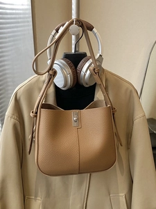Minimalist camel lychee grain bucket bag with silver twist lock and adjustable shoulder strap