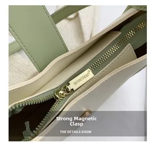Close-up of contrast color bucket bag showing interior metal zipper and magnetic buckle