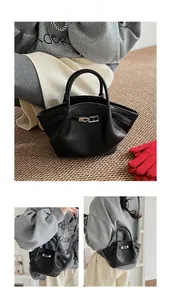 Detail view of black litchi grain leather bucket bag with silver hardware accents