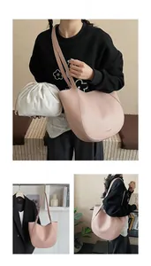Detailed view of pink leather tote bag with canvas inner bag and wide shoulder strap