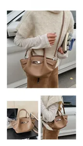 Three-way view of a brown pebbled leather bucket bag with silver metal buckle and strap