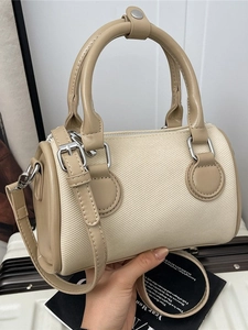 Elegant ivory canvas Boston bag with khaki leather trim and silver metal hardware accents