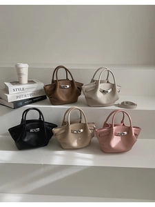 Detailed display of five small bucket bags in various colors on a white minimalist shelf
