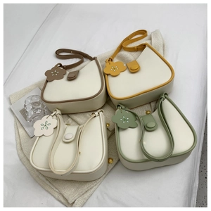 Detail of colorful PU leather bucket bags with flower charms and magnetic buckles