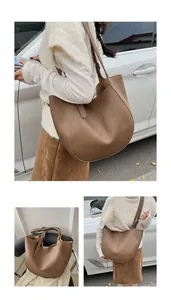 Brown soft leather hobo tote bag with visible stitching and adjustable strap details