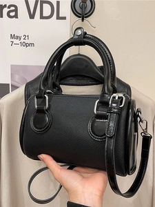 Fashionable black Boston handbag for women with textured fabric and leather trim