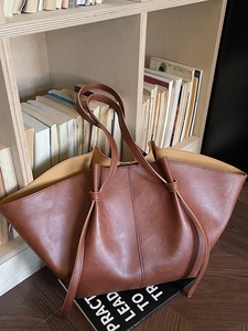 Retro dark brown oversized tote bag in glossy faux leather with decorative drawstrings