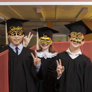Three kids in caps wearing 2026 graduation paper glasses with Senior and Congrats text