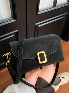 Minimalist black crossbody bag with vintage cracked leather texture and gold hardware