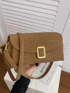 Brown leather crossbody handbag with gold rectangle buckle and adjustable shoulder strap