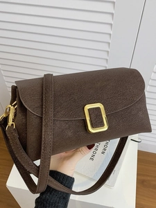 Dark brown matte leather shoulder bag with a gold rectangular metal buckle detail