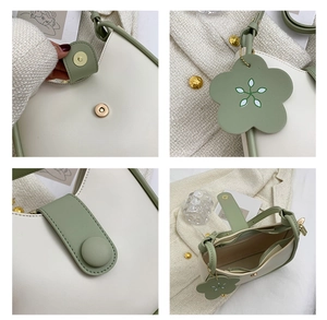 Detail showing magnetic closure, floral charm and interior pocket of cream green handbag