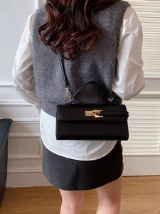 Chic black litchi pattern baguette bag with gold lock and adjustable shoulder strap