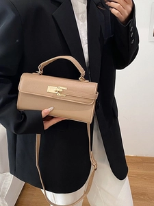 Chic beige textured crossbody baguette bag with gold metal buckle and top handle strap