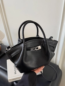 Chic black pebble grain leather bucket bag with silver buckle and detachable shoulder strap