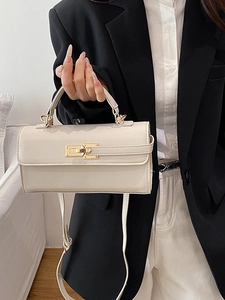 Fashionable cream baguette handbag with golden twist lock and thin shoulder strap
