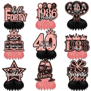 Detail view of nine 40th birthday honeycomb table centerpieces in rose gold and black