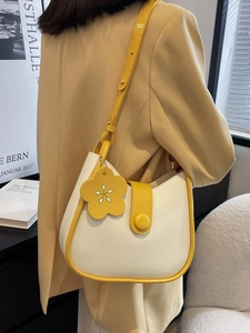 Hobo bucket bag in yellow and cream contrast with floral charm and adjustable strap