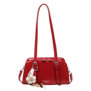 Red glossy leather tote bag with dual shoulder straps and floral charm decoration