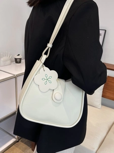 Minimalist white semi-circle underarm bag with flower charm and magnetic closure