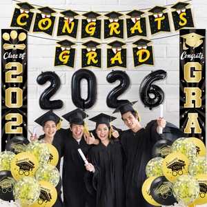 Close-up of 2026 graduation party kit with Congrats Grad banners and black gold balloons