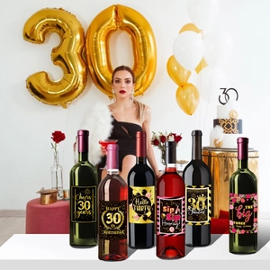 Detail view of 6 distinct black and gold 30th birthday wine bottle label stickers