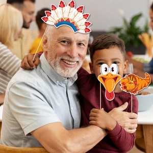 Family wearing Thanksgiving photo booth props with turkey masks and feather headbands