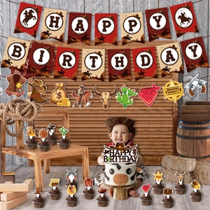 Detail of Western cowboy theme birthday banner and paper cake toppers on rustic wood wall