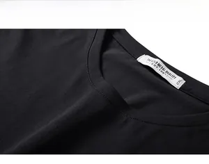Detail of a crew neck collar on a black cotton T-shirt with high-quality stitching