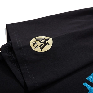 T-shirt noir en coton avec logo doré imprimé et détails brodés en paillettes bleues