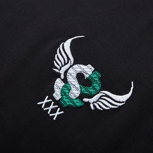 Loose fit black cotton T-shirt featuring detailed wing embroidery and white text detail