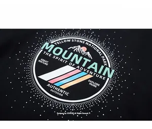 Detail of mountain print with sparkling rhinestones on oversized black sweatshirt