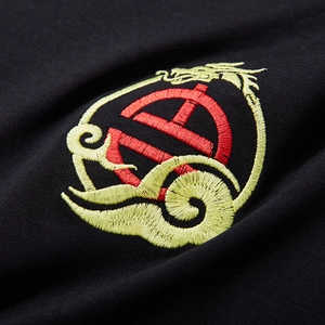 Black cotton t-shirt featuring intricate yellow dragon embroidery and red symbol