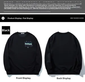 Macro view of black crewneck sweatshirt featuring blue planet print and star graphics