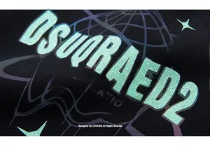 Close-up of glittery mint green DSUQRARD2 lettering and purple space graphics on black hoodie