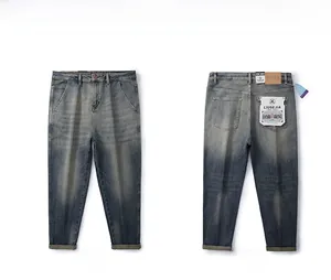 Front and back view of vintage blue-grey washed straight jeans with leather waist patch