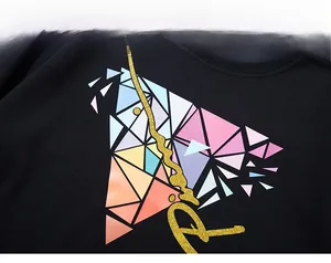 Close-up of geometric triangle print with gold sequin edges on black cotton sweatshirt