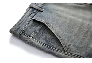 Close-up of vintage washed light blue denim jeans showing pocket details and texture