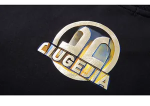Close-up of premium gold metallic LIUGEJIA logo printed on black cotton sweatshirt fabric