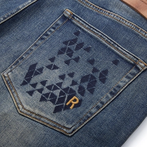 Men's retro washed straight denim jeans featuring embroidered back pocket and orange R logo