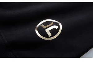 Macro shot of high-quality black sweatshirt fabric with a premium gold foil logo print