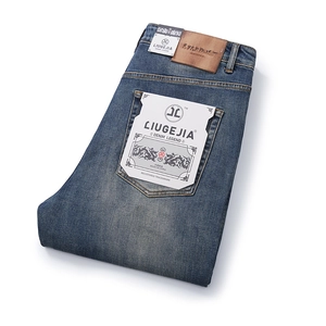 Men's vintage washed straight leg jeans with brown leather patch and folded denim details
