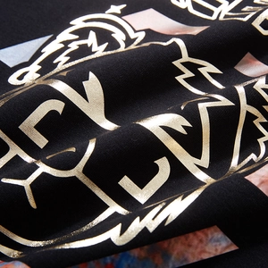 Oversized black sweatshirt featuring golden foil letter print and artistic graphic detail