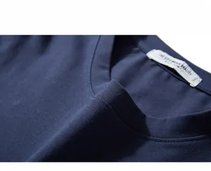 Detailed view of the neckline on a dark blue cotton t-shirt featuring the XXL size tag