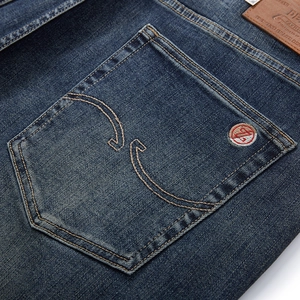 Men's loose straight-leg denim jeans featuring vintage wash and logo embroidery detail