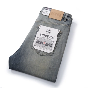 Men's retro light blue straight leg denim jeans with vintage washed finish and leather patch