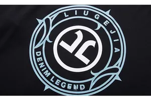 Macro detail of high-quality blue letter print on black cotton long-sleeve t-shirt
